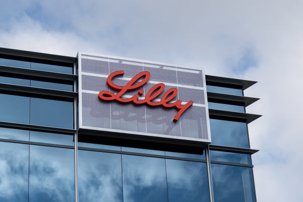 A commercial building with a sign reading "Lilly" in red cursive writing.