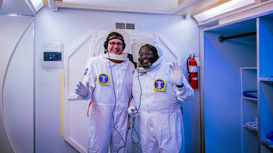 Two Adult Space Academy participants waive at the camera