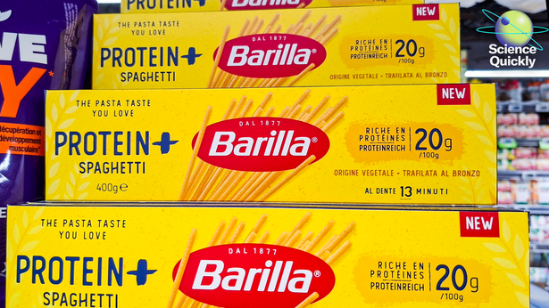 An image of boxes of Barilla Protein Plus pasta displayed on a shelf in a supermarket, highlighting a high protein content