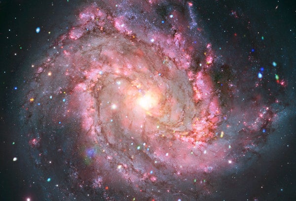 Galaxy M83 appears as a mass of pink dust and stars in x-ray and optical light.