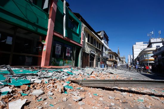 A street covered in rubble following an earthquake.