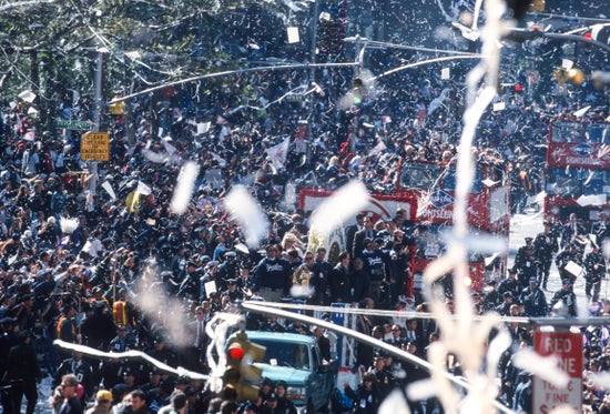 Ticker-tape parade confetti in front of a crowd.