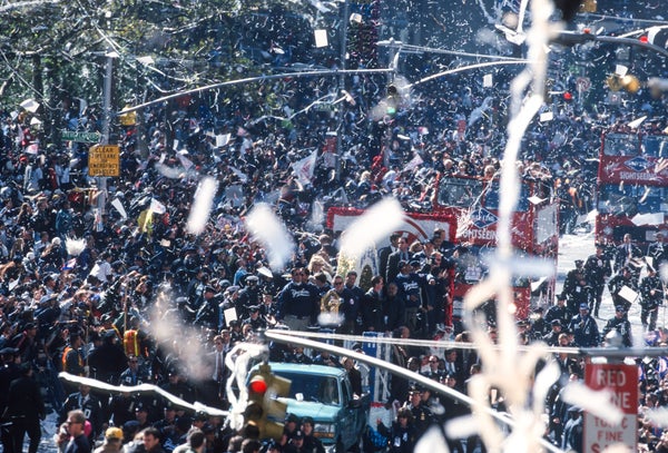 Ticker-tape parade confetti in front of a crowd.
