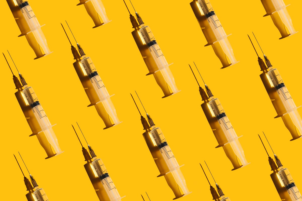 syringes on a yellow background to illustrate peptide injections for wellness