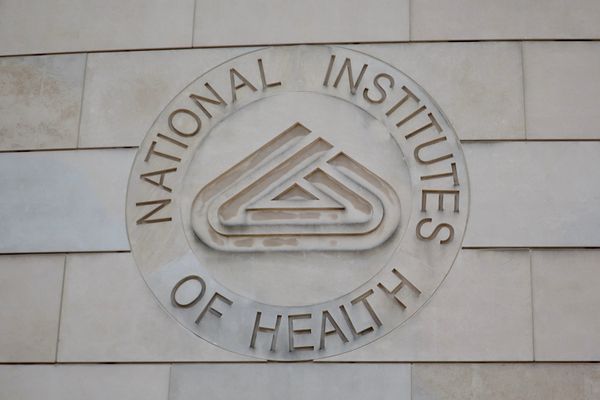 The emblem of the National Institutes of Health on a building at the NIH campus.