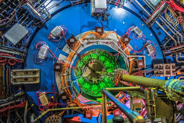 Large blue and green circles make up the STAR detector at RHIC.