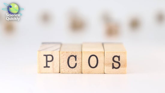 Wooden blocks with letters spell PCOS against a blurry white background