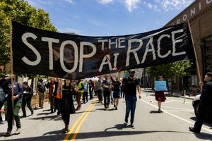 Protestors on the streets of San Francisco. Four hold a banner reading "STOP THE AI RACE."