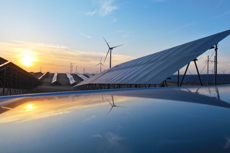 Solar panels with the sunset behind them