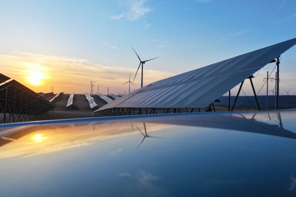 Solar panels with the sunset behind them