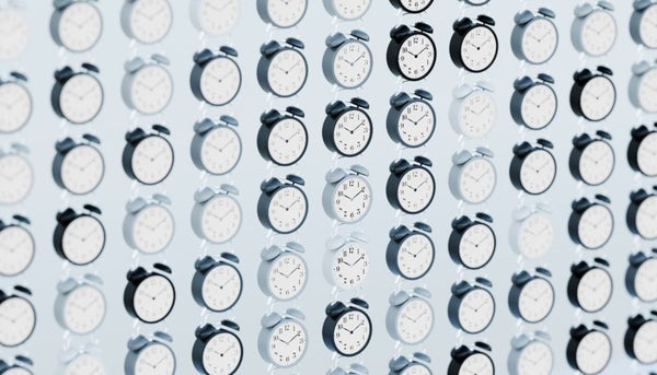 An image of a wall full of clocks.