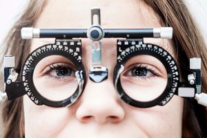 Girl with eye test equipment.