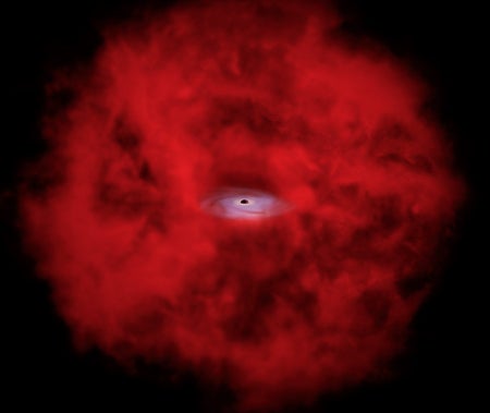 A growing supermassive black hole sits at the center of a vast red cloud of gas and dust in this artist’s concept.
