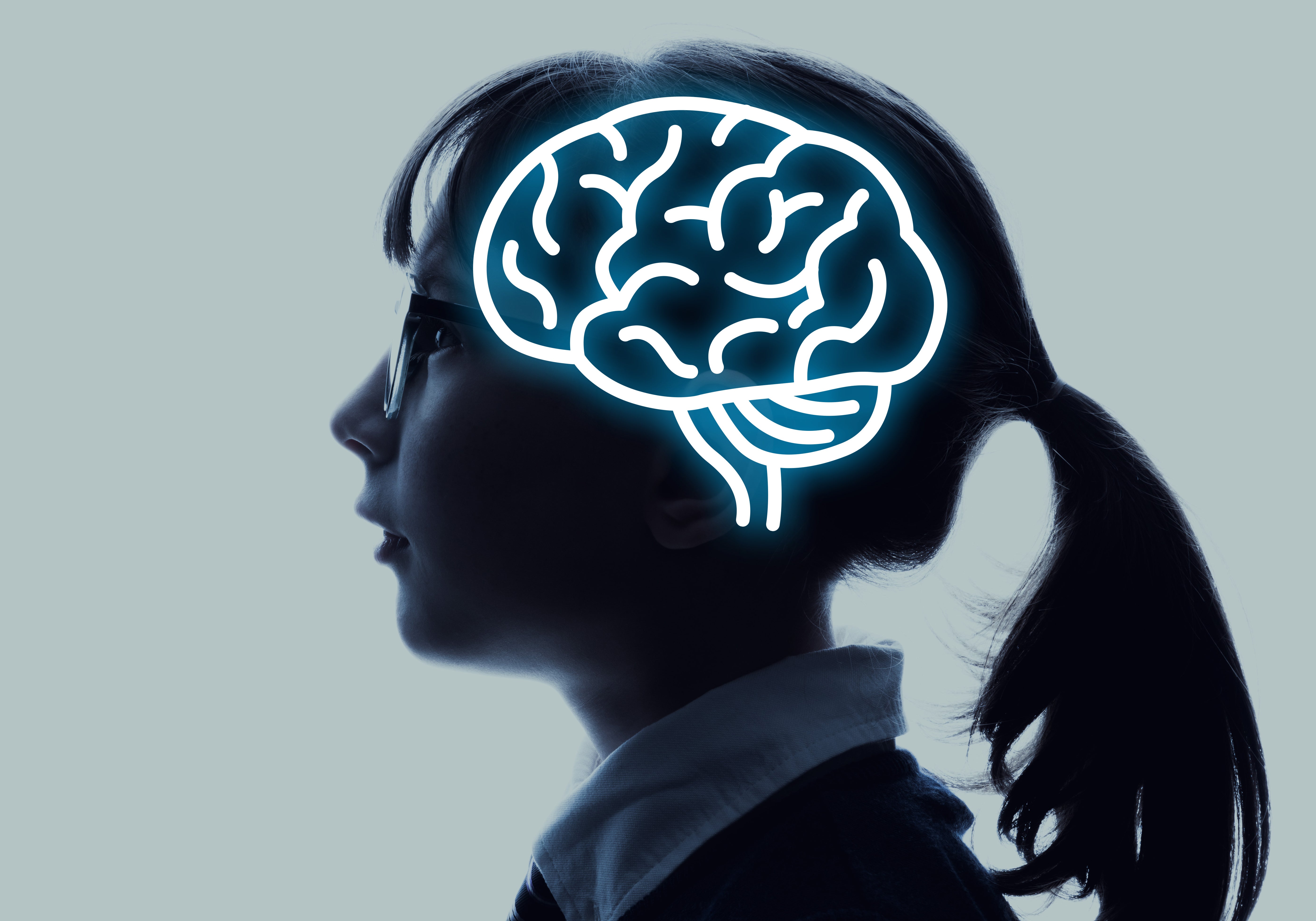 Profile of a girl with a brain illustration overlay.
