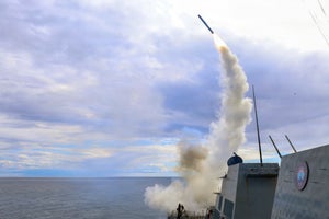 Photo of a Tomahawk missile being launched from a carrier in the ocean