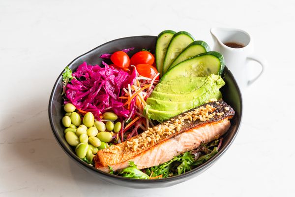 A fresh grilled salmon salad with colorful vegetables.