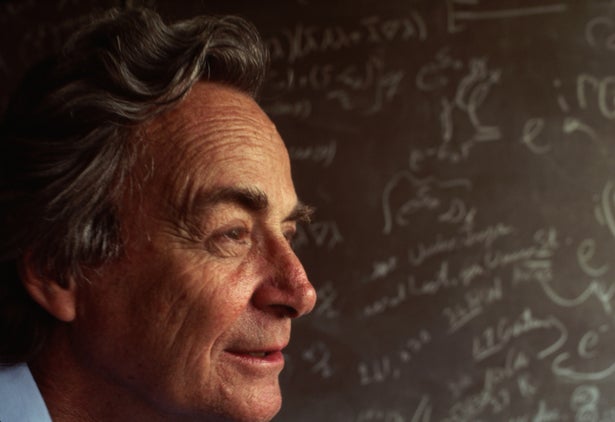 Nobel Prize winning physicist Richard Feynman stands in front of a blackboard strewn with notation in his lab in Los Angeles, Californina.