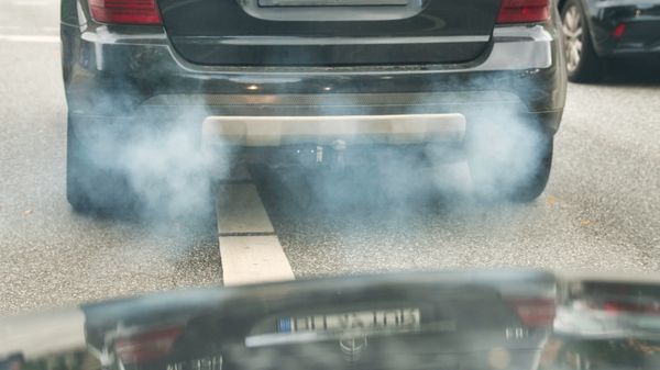 Exhaust fumes from behind a car.