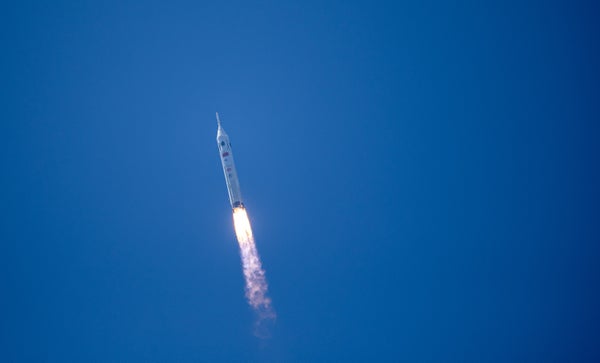 صاروخ صيني من طراز لونج مارش 10 يحلق في سماء زرقاء صافية فوق عمود ناري من عادم السيارة