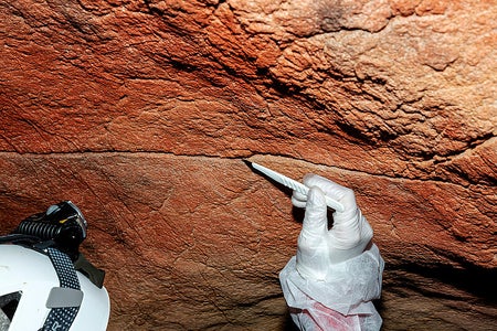 Pigment sampling at a claviform rock art figure in Tebellín, Spain.
