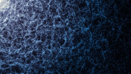 A small portion of DESI’s year-five map in which the large-scale structure of the universe, created by gravity, is visible. Each dot represents a galaxy. The denser areas indicate regions where galaxies and galaxy clusters have clumped together to form the strands of the cosmic web. Also seen are large voids between the filaments.