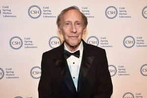 Bob Langer in a black suit, standing against a Cold Spring Harbor Laboratory background.
