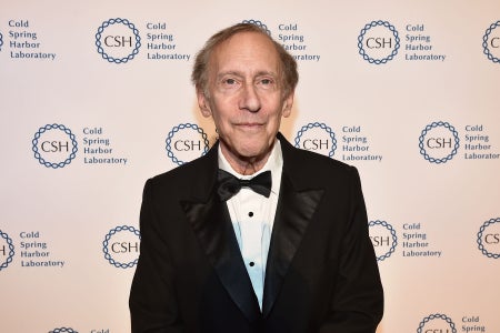 Bob Langer in a black suit, standing against a Cold Spring Harbor Laboratory background.