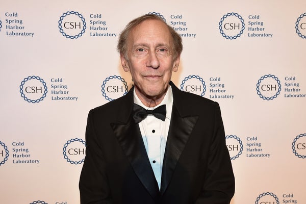 Bob Langer in a black suit, standing against a Cold Spring Harbor Laboratory background.