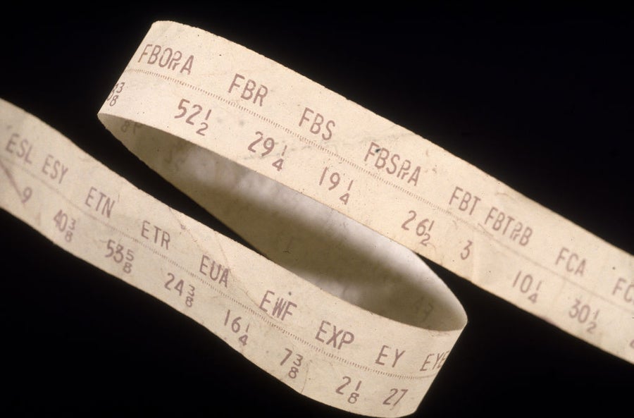 Close-up of ticker tape against black background.