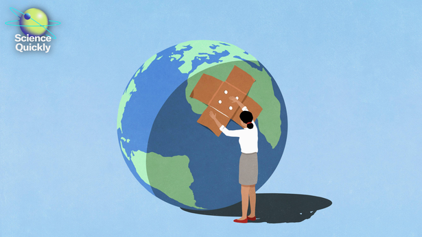 Conceptual image showing a woman placing a bandange of a large globe against a blue background