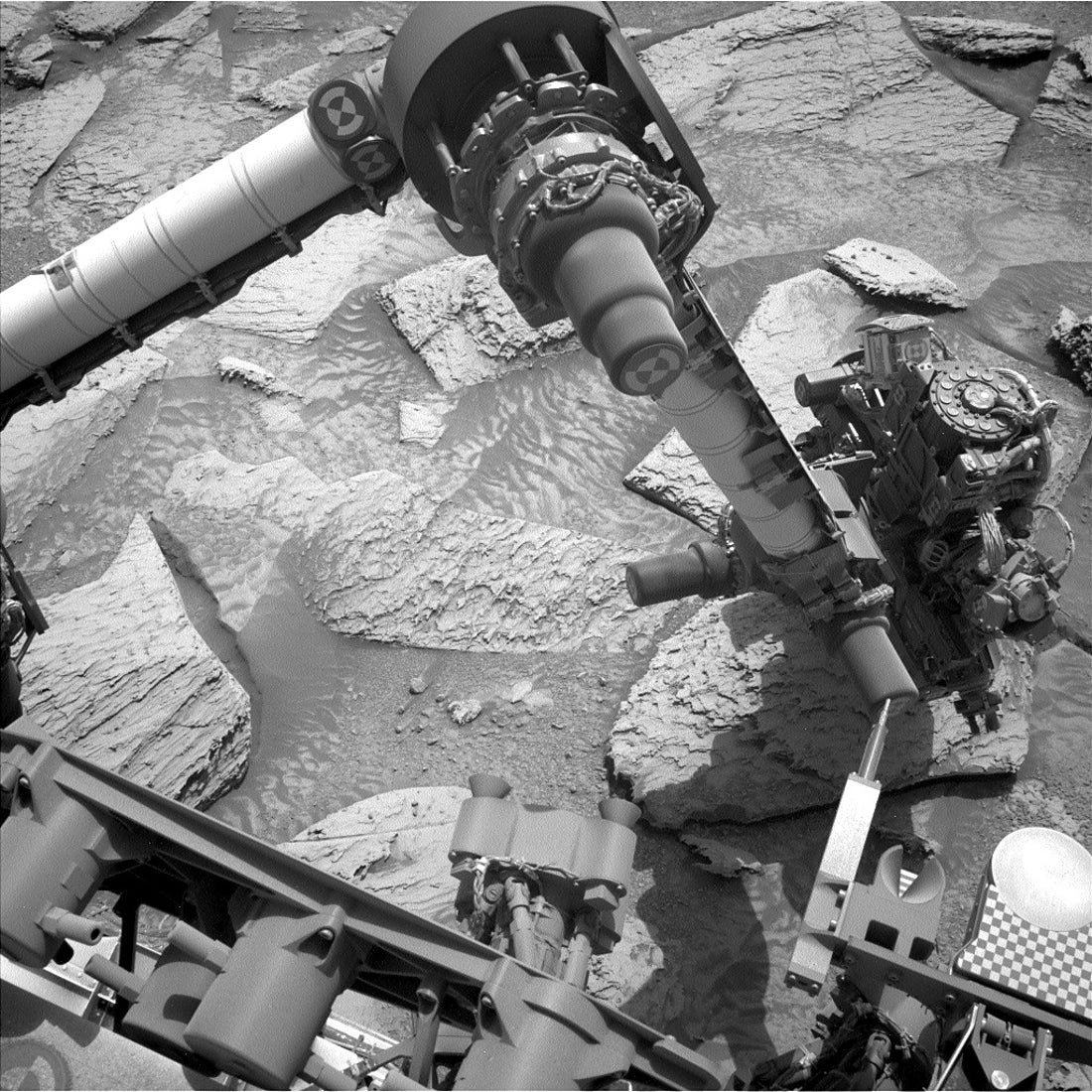 GIF of Curiosity attempting to shake a Martian rock loose.