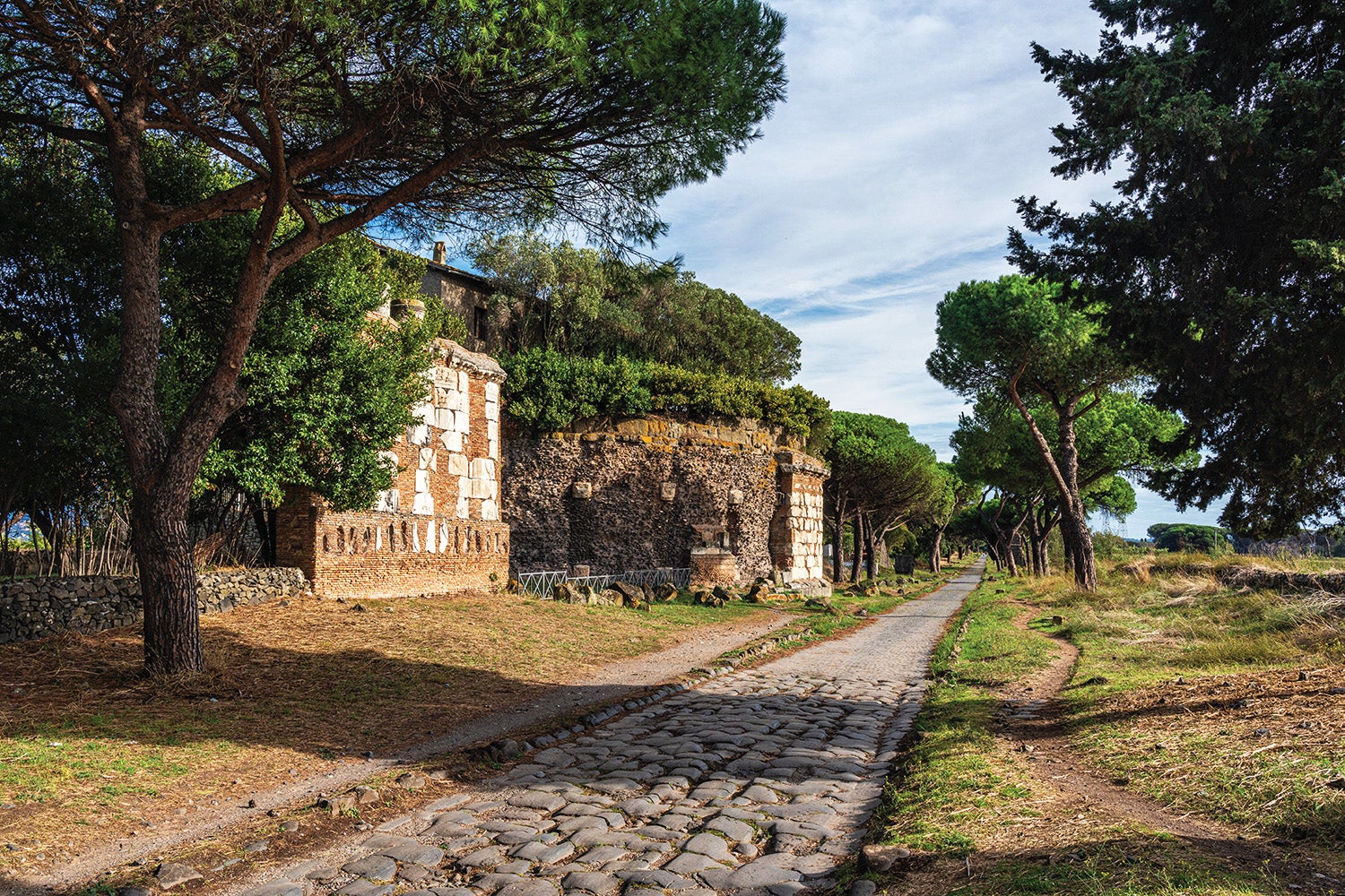 A stretch of the Via Appia showing the straight construction and stone paving associated with classic Roman roads