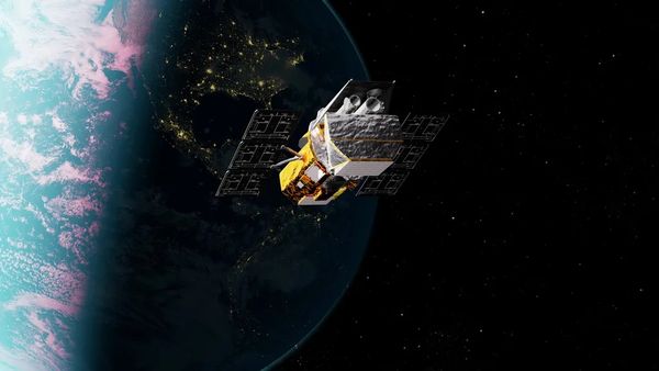 A space telescope soars over the dayside and nightside of Earth.