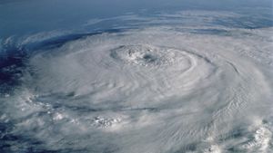 A classic hurricane with spinning clouds and a central eye is seen from a oblique angle.