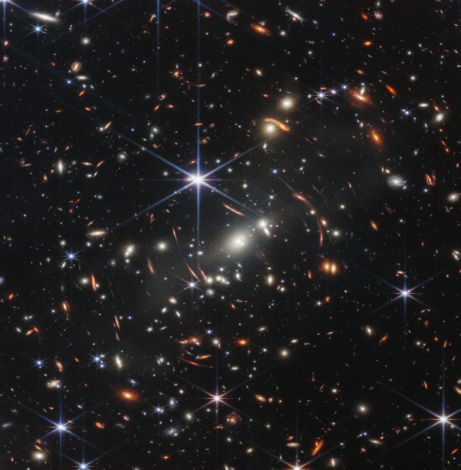 Hundreds of blobs, smudges and flares against a black background represent galaxies and stars in this deep-field image of the night sky. Provided by NASA, ESA, CSA and STScI.