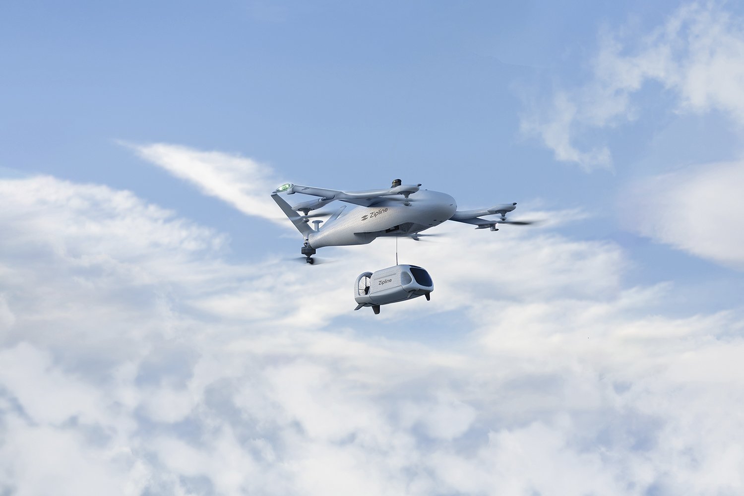 Aerial photo provided by Zipline of it's drone plane carrying the land drone for deliveries.