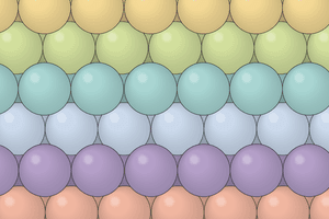 Graphic shows colored spheres packed together in a three-dimensional grid.
