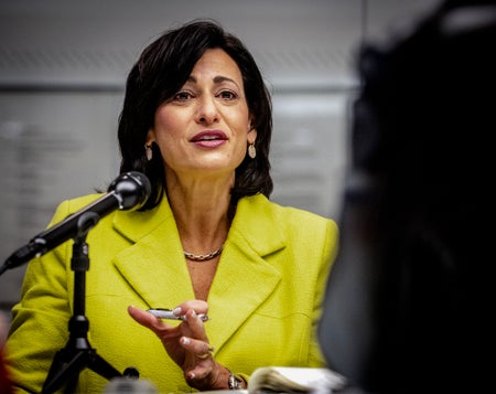 Then CDC director Rochelle Walensky, in a yellow suit, meets with Washington Post editors and reporters in December 2022.