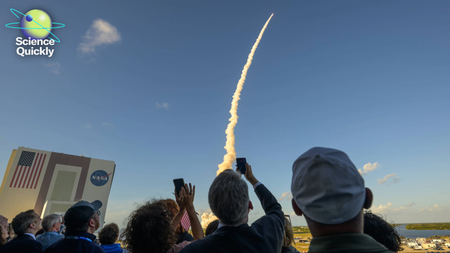 An image of the back of a group of people's heads as they watch NASA's Artemis II mission launch from Florida.