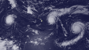 A satellite view of three hurricanes surrounding the Hawaiian islands.