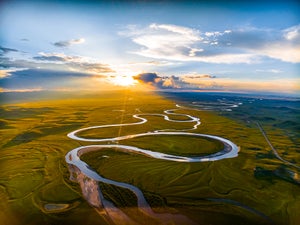 A windy river over a scenic landscape.