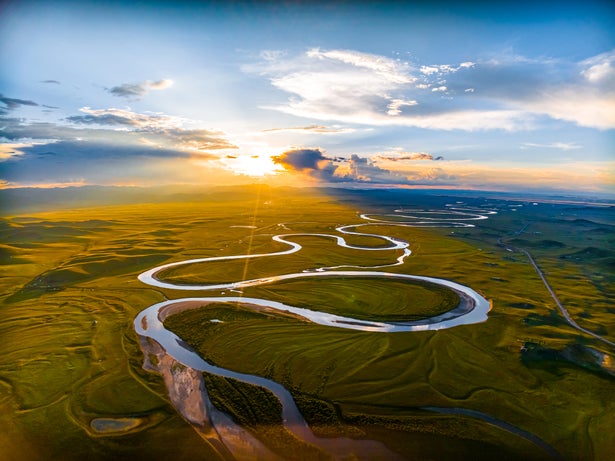 A windy river over a scenic landscape.