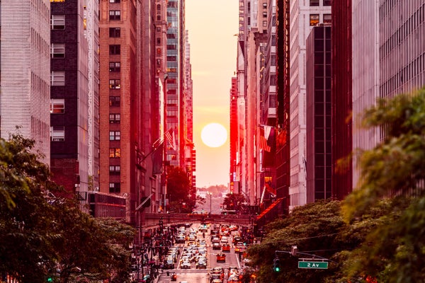 Sun setting between skyscrapers on 42nd street during Manhattanhenge