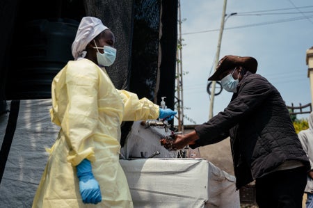 A visitor washes his hands before entering Kyeshero Hospital at a checkpoint for hand washing and temperature screening for all visitors and patients entering Kyeshero Hospital, as part of Ebola prevention measures in Goma on May 18, 2026.