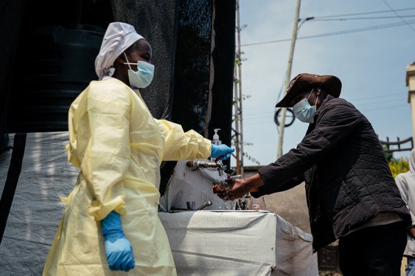 A visitor washes his hands before entering Kyeshero Hospital at a checkpoint for hand washing and temperature screening for all visitors and patients entering Kyeshero Hospital, as part of Ebola prevention measures in Goma on May 18, 2026.