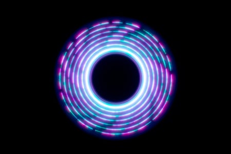 An abstract circle shape spins a light trail on a black background.