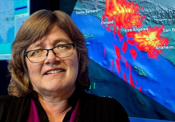 Lucy Jones posing in front of a seismic map of California.