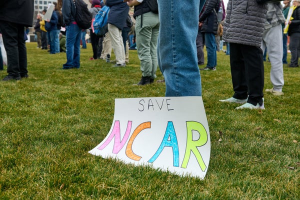 A colorful sign calling to save the National Center for Atmospheric Research.