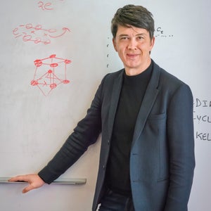 Gerd Ceder standing in front of a white board.