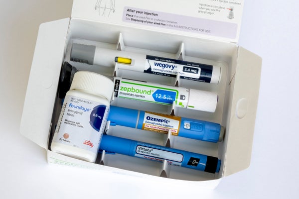 Photo illustration of a group of weight loss medications on a white background.